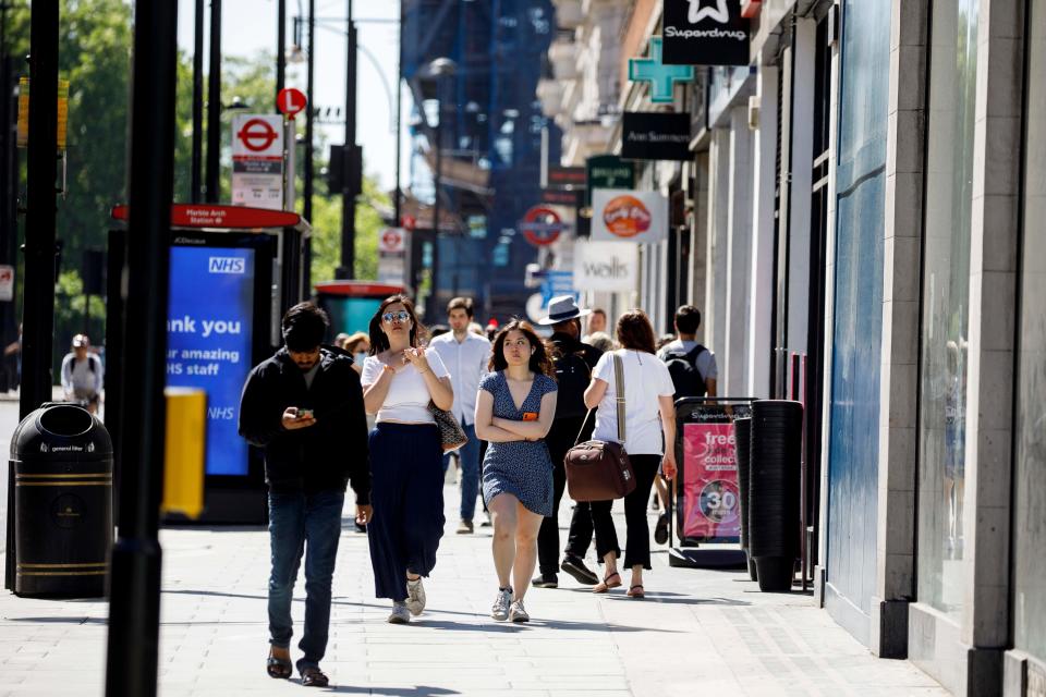 People walk past closed shops on Oxford Street in central London's main high street retail shopping area on May 29, 2020 ahead of some shops reopening from their coronavirus shutdown from next week. - The UK Prime Minister announced on May 28 that some English schools and shops would reopen from next week people would a little more freedom to meet others in public as he tried to plot Britain's path through a health disaster that has officially claimed 37,837 lives -- second only to the United States -- and devastated the economy. (Photo by Tolga AKMEN / AFP) (Photo by TOLGA AKMEN/AFP via Getty Images)