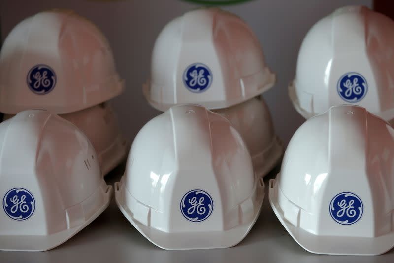 FILE PHOTO: The General Electric logo is pictured on working helmets during a visit at the General Electric offshore wind turbine plant in Montoir-de-Bretagne, France