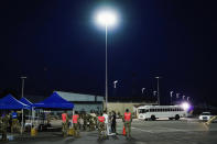 A bus carrying people flown out of Afghanistan heads to the medical screening station at Ramstein Air Base, in Ramstein-Miesenbach, Germany, Friday, Aug. 20, 2021. (Uwe Anspach/dpa via AP)