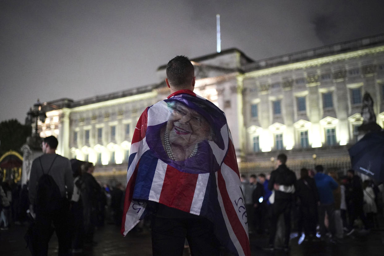 Image: Mourners gather outside Buckingham Palace following the announcement of the death of Queen Elizabeth II on Thursday. (James Manning / PA via AP)