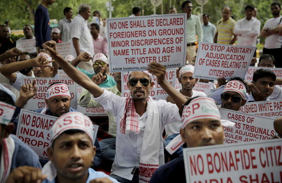 In this Saturday, Aug. 4, 2018, file photo, activists shout slogans during a protest in front of Assam House against the final draft of the National Register of Citizens (NRC) in the northeastern state of Assam, in New Delhi, India. India has been embroiled in protests since December, when Parliament passed a bill amending the country's citizenship law. (AP Photo/Altaf Qadri, File)