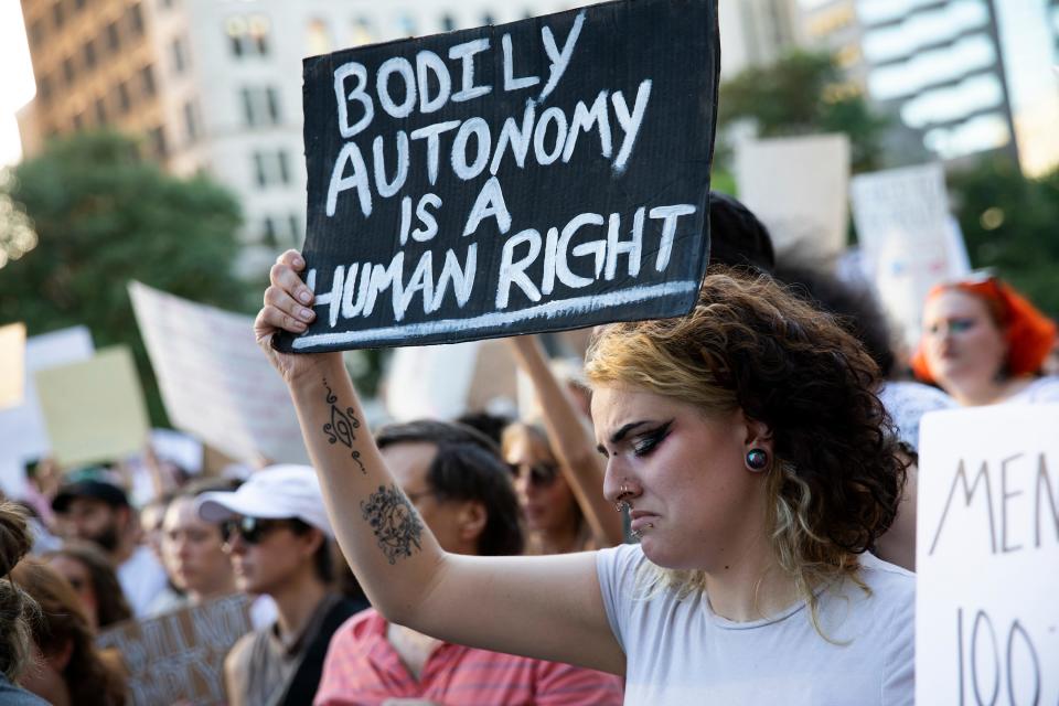 Jun 24, 2022; Columbus, Ohio, USA;  Emily Corbin holds up a sign during a rally at the Ohio Statehouse following the overturning of Roe v Wade by SCOTUS. Mandatory Credit: Brooke LaValley-The Columbus Dispatch