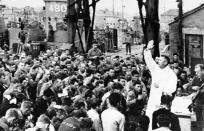 These members of the first groups of assault troops to take part in the Allied invasion of Northern France receive a benediction from an Army chaplain before leaving England on June 6, 1944, for the European continent. Their assault craft can be seen in the background. (Photo: AP)