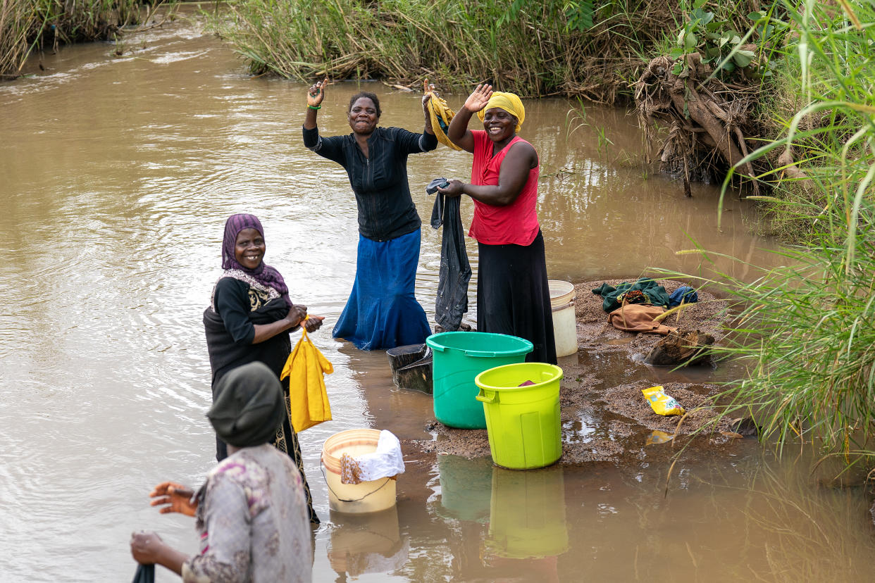 Women wash clothes in a river in the Machinga region of Malawi (Brian Lawless/PA)