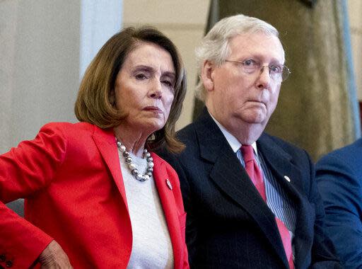 In this March 21, 2018, file photo Nancy Pelosi of Calif.,  and Senate Majority Leader Mitch McConnell of Ky., attend a Congressional Gold Medal Ceremony honoring the Office of Strategic Services in Emancipation Hall on Capitol Hill in Washington. Pelosi and McConnell are coming together to see if a deal can be made to stop billions of dollars in government spending cuts. Failure to reach an agreement would usher in cuts to the Pentagon and domestic programs of $125 billion next year _ a 10 percent drop from current levels.