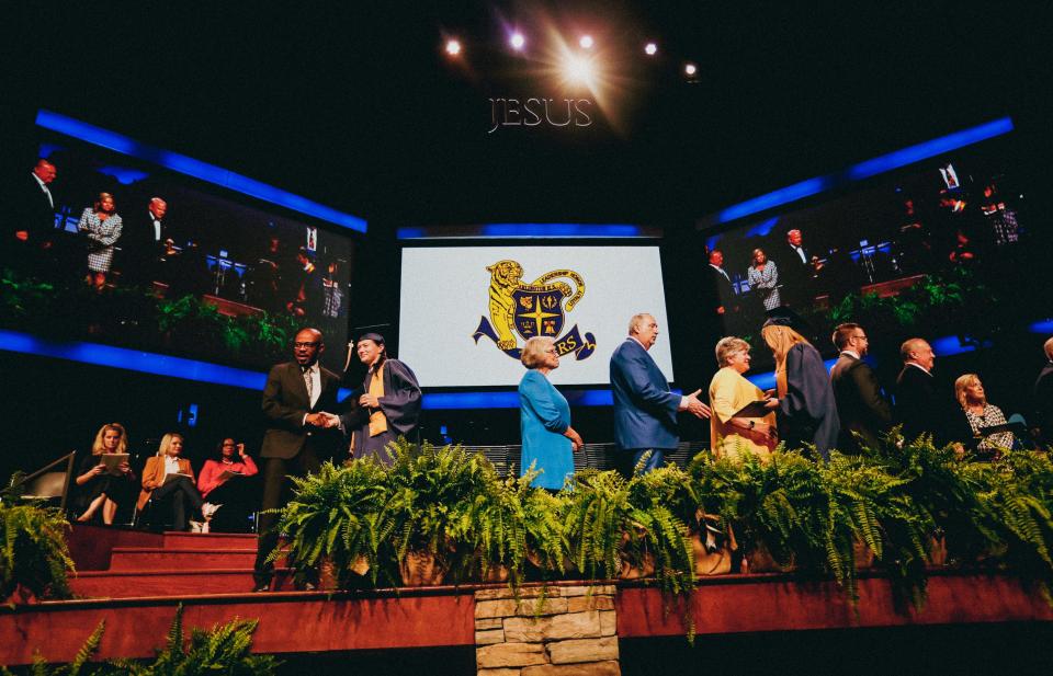 Graduates receive their diplomas during the Arlington High School graduation ceremony on Tuesday, May 07, 2024 at Bellevue Baptist Church in Memphis.