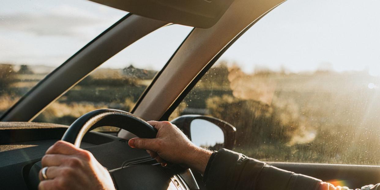 hand holding steering wheel in a car