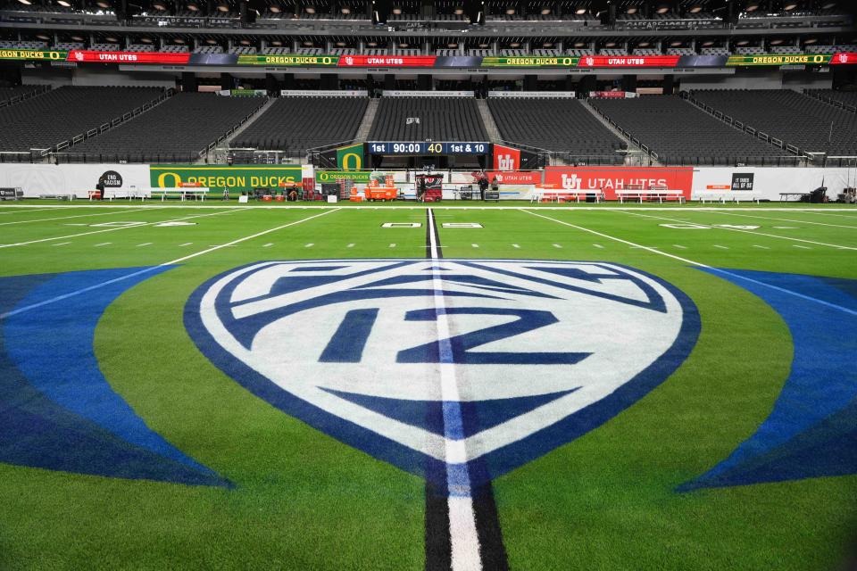 A view of the Pac-12 Conference logo at midfield of Allegiant Stadium in Las Vegas before the Pac-12 championship game between the Oregon Ducks and the Utah Utes.