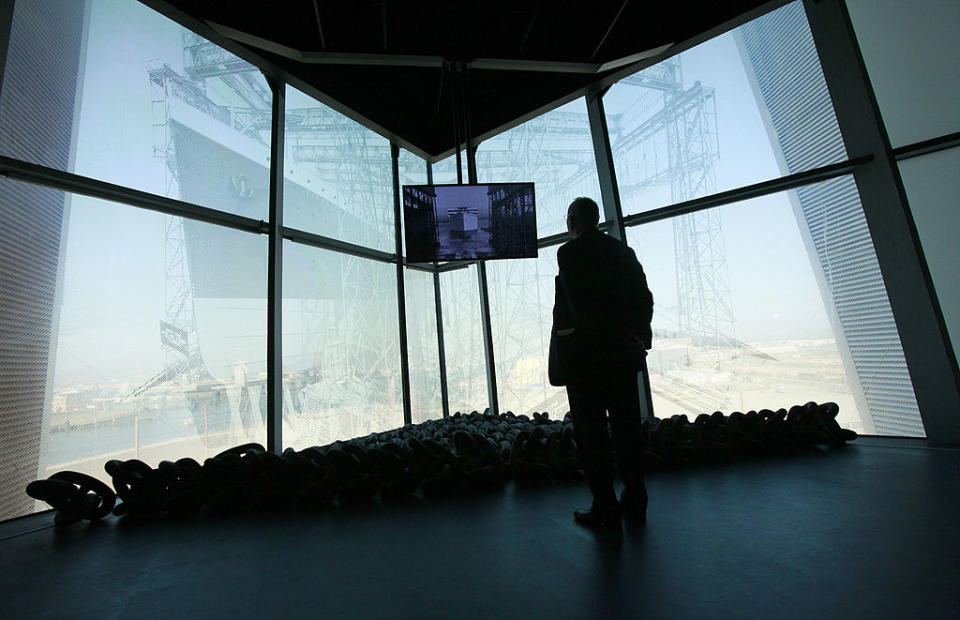 person watching footage in the museum