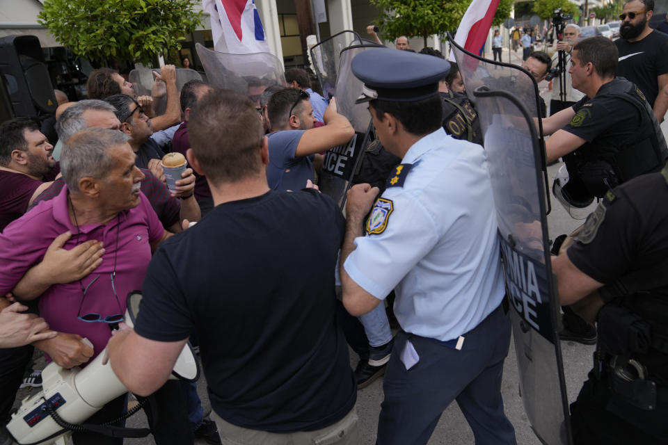 Police clash with protesters outside a court house in Kalamata, southwestern Greece, on Tuesday, May 21, 2024. Nine Egyptian men go on trial in southern Greece on Tuesday, accused of causing a shipwreck that killed hundreds of migrants and sent shockwaves through the European Union’s border protection and asylum operations. (AP Photo/Thanassis Stavrakis)
