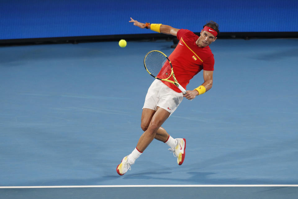 Rafael Nadal of Spain plays a shot against Novak Djovovic of Serbia during their ATP Cup tennis match in Sydney, Sunday, Jan. 12, 2020. (AP Photo/Steve Christo)