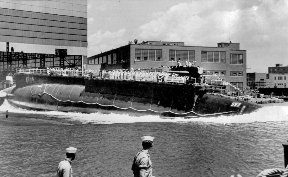 FILE - In this July 9, 1960, file photo, the U.S. Navy nuclear powered attack submarine USS Thresher is launched bow-first at the Portsmouth Navy Yard in Kittery, Maine. In 1963, the crew of a rescue ship listened helplessly after receiving an ominous message “exceeding test depth” before the USS Thresher disintegrated under the crushing pressure of the sea in 1963. Killed were 129 sailors and civilians on a routine test dive off Cape Cod. (AP Photo, File)