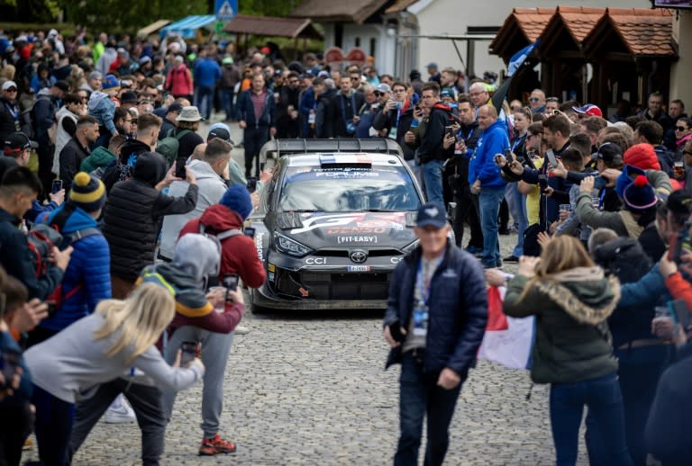 Sebastien Ogier threads his Toyota between the fans before Sunday's final stage (DAMIR SENCAR)