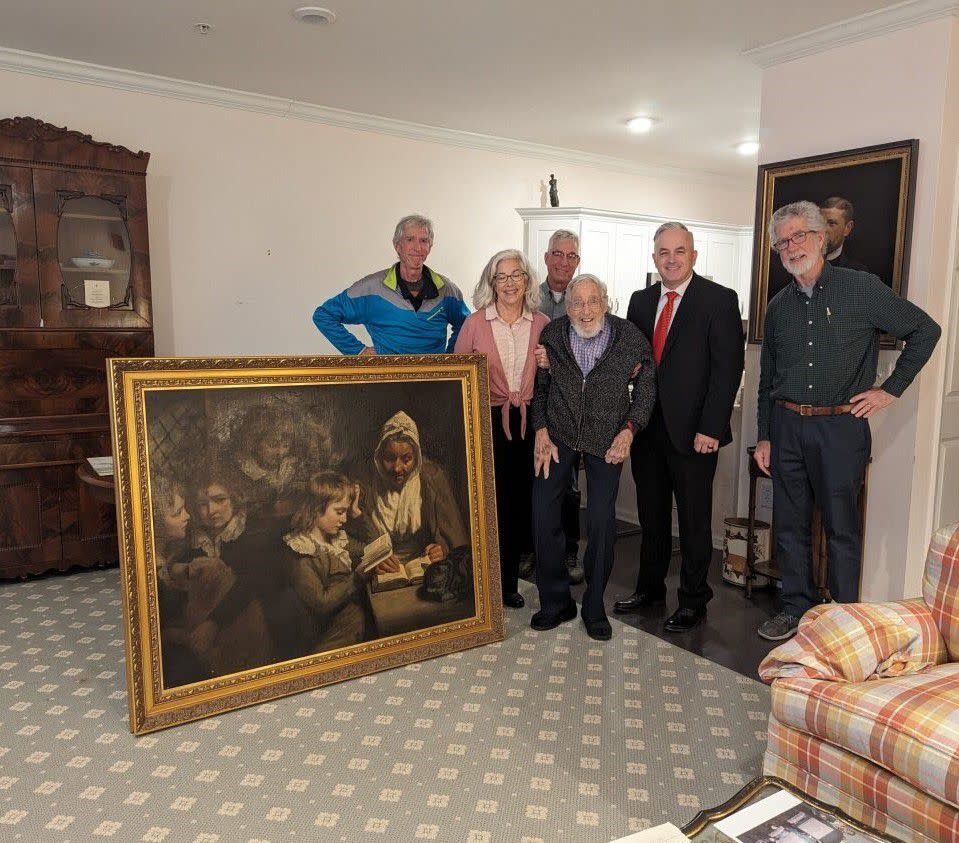 Special Agent Gary France (second right), Dr. Francis Wood and Wood’s children stand next to the John Opie painting that was stolen from Wood’s parents’ home in 1969.&nbsp;