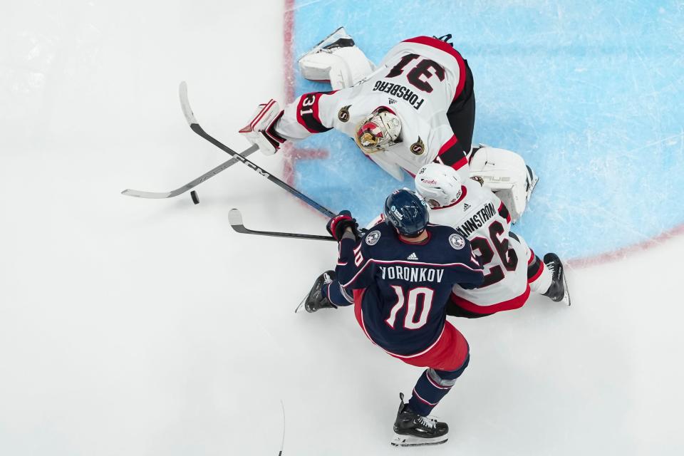 Mar 14, 2024; Columbus, Ohio, USA; Ottawa Senators goaltender Anton Forsberg (31) saves a shot from Columbus Blue Jackets left wing Dmitri Voronkov (10) in front of Ottawa Senators defenseman Erik Brannstrom (26) during the second period of the NHL hockey game at Nationwide Arena.