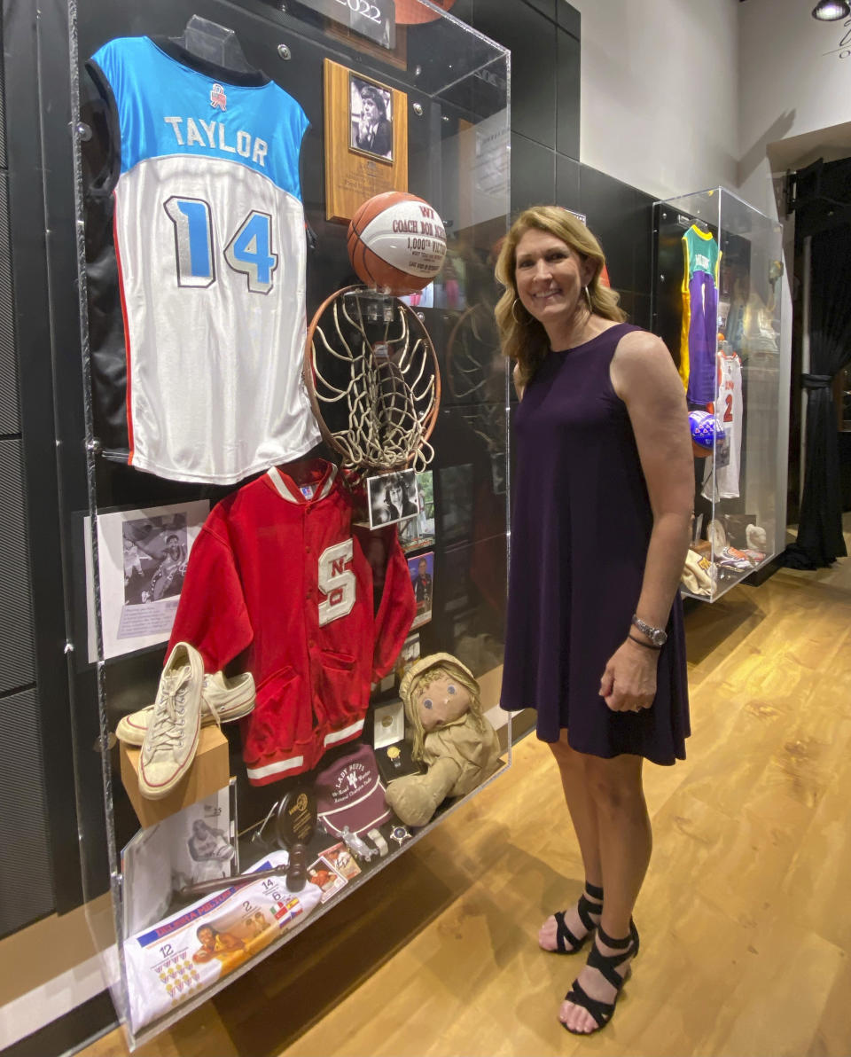 Debbie Antonelli, a 2022 inductee into the Women's Basketball Hall of Fame as a contributor poses next to the hoop she used growing up, Saturday, June 11, 2022 in Knoxville, Tenn. Debbie Antonelli, Becky Hammon, Doug Bruno and Penny Taylor are among the 2022 inductees Saturday night into the Women’s Basketball Hall of Fame. Title IX also is being honored with the hall’s Trailblazers of the Game award at its 50th anniversary. (AP Photo/Teresa M. Walker)