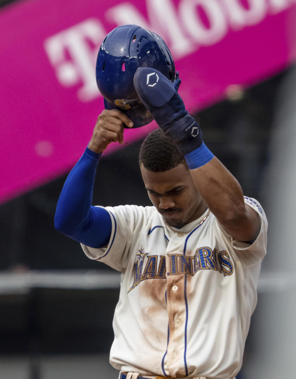 Seattle Mariners' Julio Rodriguez acknowledges the crowd after stealing a base during the fifth inning of the team's baseball game against the San Diego Padres, Wednesday, Sept. 14, 2022, in Seattle. Rodriguez has hit 25 home runs and stolen 25 bases in his rookie season. (AP Photo/Stephen Brashear)