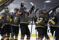 Vegas Golden Knights celebrate after defeating the Arizona Coyotes in an NHL hockey game Monday, Jan. 18, 2021, in Las Vegas. (AP Photo/John Locher)