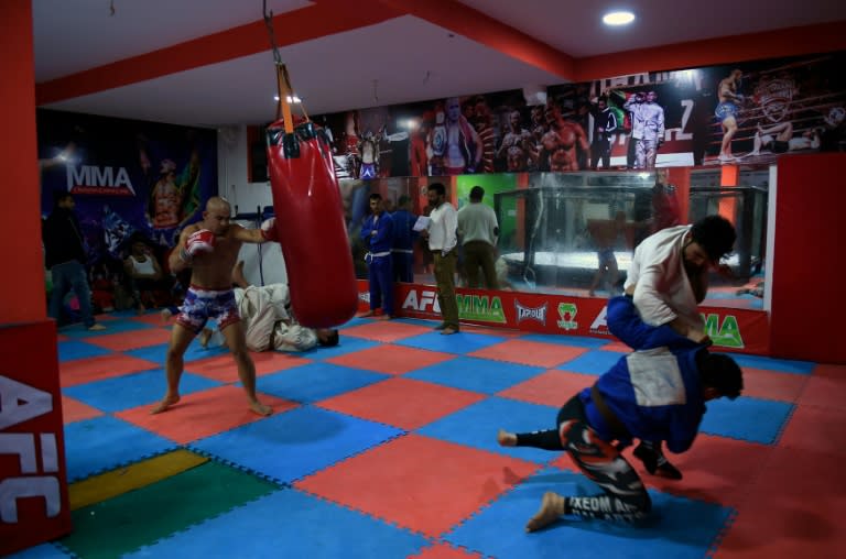 Afghan mixed martial arts (MMA) fighter Baz Mohammad Mubariz (L) trains ahead of his bout with Ahmad Wali Hotak, with both vowing to knock each other senseless and calling each other a "fake champion"