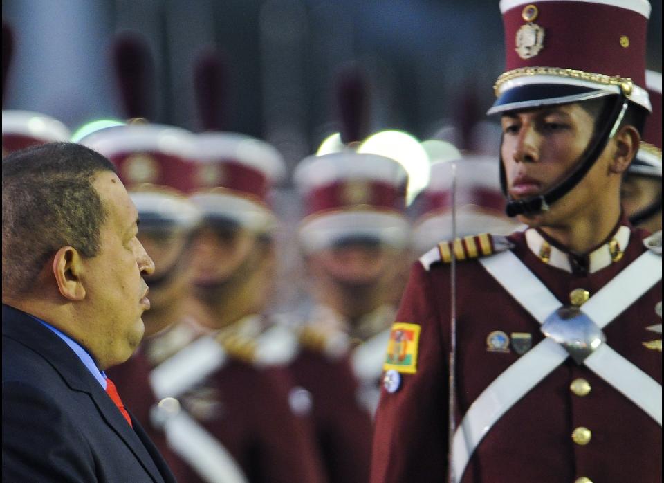 Venezuelan President Hugo Chavez review cadets during the military inauguration ceremony of his new Defense Minister Gen. Henry Rangel Silva (not in frame) on January 17, 2012 in Caracas. AFP PHOTO/Leo RAMIREZ (Photo credit should read LEO RAMIREZ/AFP/Getty Images)