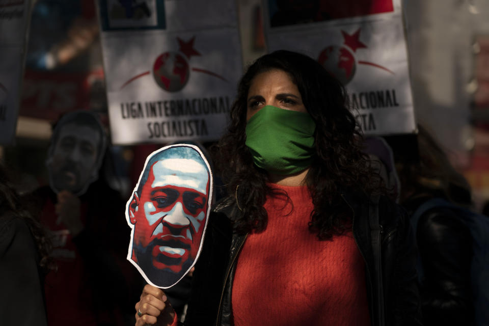 Argentine socialist leader Celeste Fierro leads a march in central Buenos Aires, Argentina, on Tuesday, June 2, 2020, to protest against the recent killing of George Floyd by police officers in Minneapolis, that has led to protests in many countries and across the US. A few hundred people defied the mandatory lockdown imposed since March 20th to march in solidarity with U.S. protests over the killing of Floyd. (AP Photo/Victor R. Caivano)