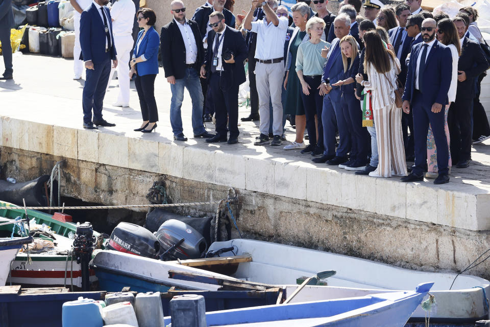 The President of the European Commission, Ursula von der Leyen, sixth from right front row, and the Italy's Premier Giorgia Meloni, fourth from right front row, visit the island of Lampedusa, in Italy, Sunday, Sept. 17, 2023. EU Commission President Ursula von der Leyen and Italian Premier Giorgia Meloni on Sunday toured a migrant center on Italy’s southernmost island of Lampedusa that was overwhelmed with nearly 7,000 arrivals in a 24-hour period this week. (Cecilia Fabiano/LaPresse via AP)