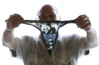 Andre Cornet holds a woman's underwear, part of a collection of about 2,200 pieces of panda collectables, in his house in Haccourt March 11, 2014. REUTERS/Yves Herman