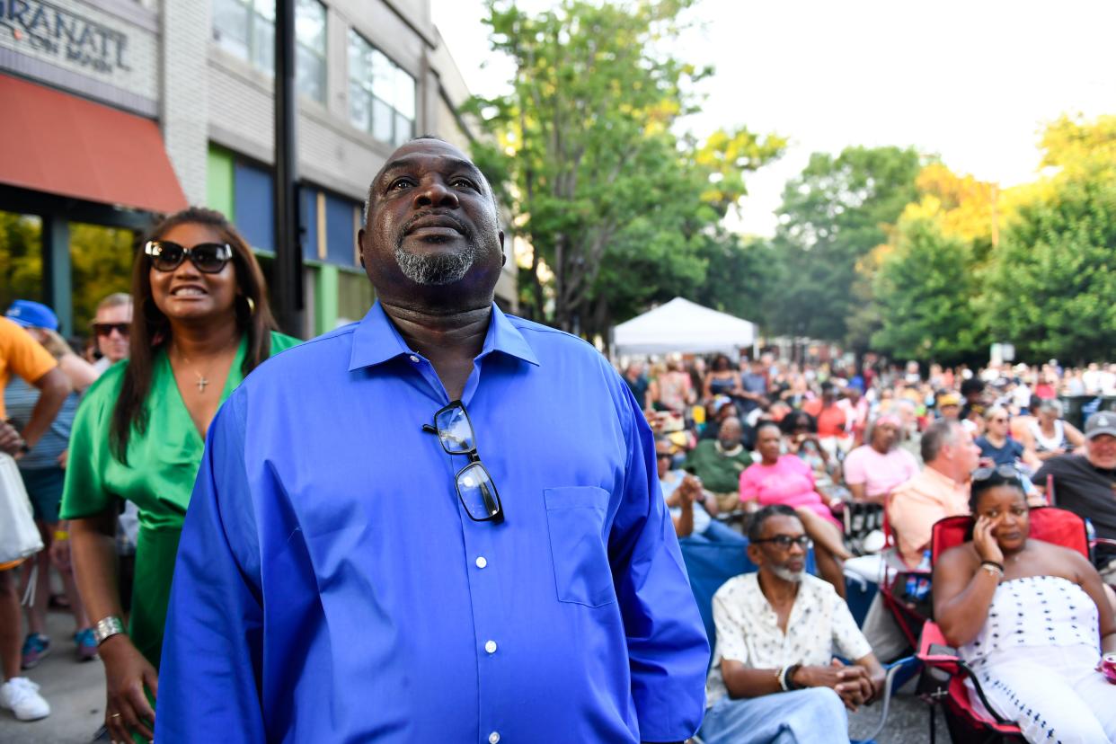 Tears are seen in Henry Thomas's eyes as he watches a performance at the Greenville Jazz Festival downtown, in celebration of his birthday alongside his sister, Margie Pizarro, left, on Saturday, June 3, 2023. This is Thomas's first birthday spent with family outside of a cell since 2008.