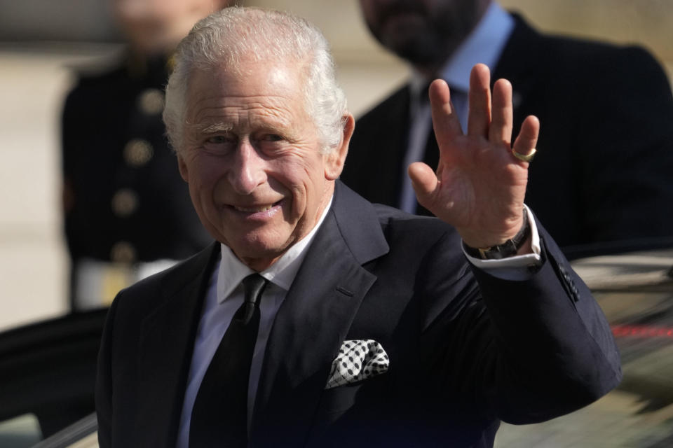 Britain's King Charles III waves to members of the public as he arrives at St. Anne's Cathedral to attend a Service of Reflection for the life of Her Majesty The Queen Elizabeth in Belfast, Tuesday, Sept. 13, 2022. King Charles III and Camilla, the Queen Consort, flew to Belfast from Edinburgh on Tuesday, the same day the queen’s coffin will be flown to London from Scotland. (AP Photo/Gregorio Borgia)