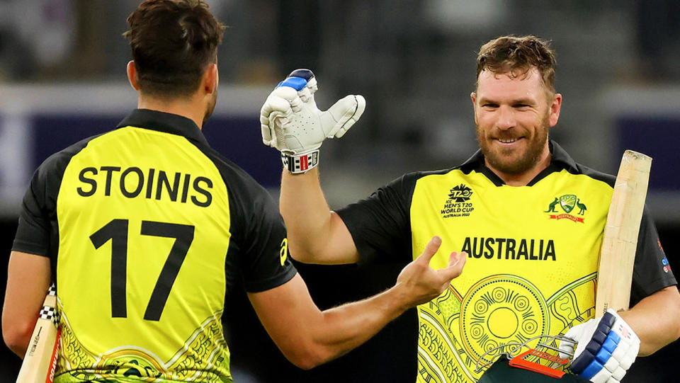 Aaron Finch shakes hands with Marcus Stoinis.