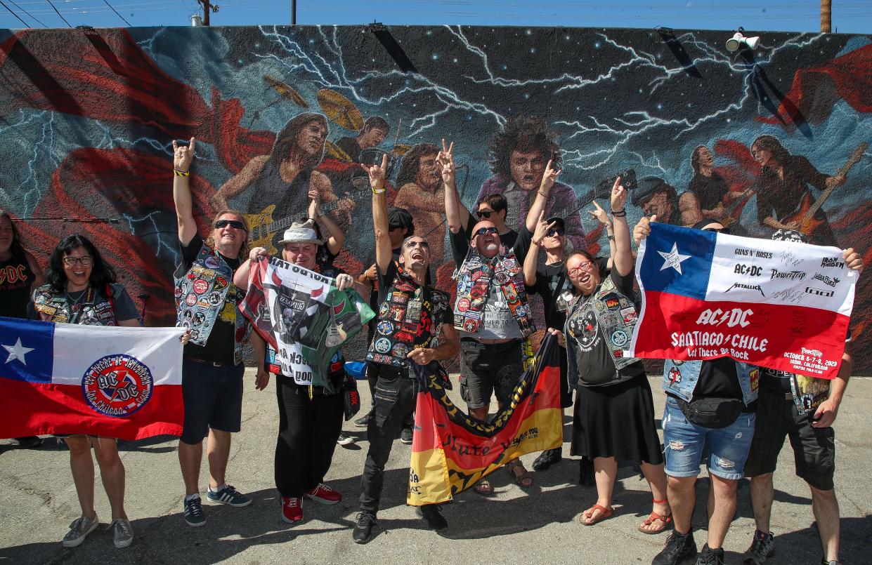 AC/DC fans from at least seven different countries rock out in front of a mural for the band at Club 5 which was transformed into a Power Trip Pop-Up bar in Indio, Calif., Oct. 5, 2023.