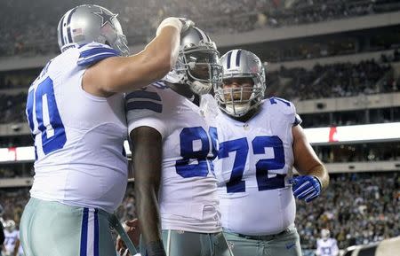 Dallas Cowboys wide receiver Dez Bryant (88) celebrates his touchdown pass with guard Zack Martin (70) and center Travis Frederick (72) in the first quarter at Lincoln Financial Field. Mandatory Credit: Eric Hartline-USA TODAY Sports