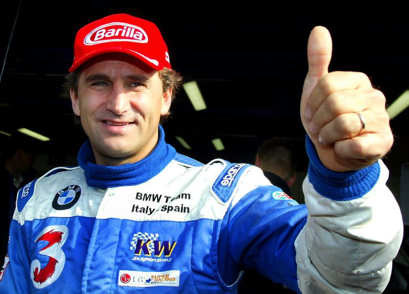 FILE PHOTO: Italian BMW 320i racing car driver Zanardi gives a thumbs up