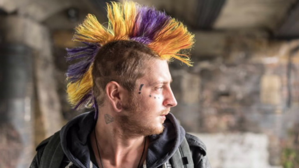 Un hombre con el pelo pintado de muchos colores.