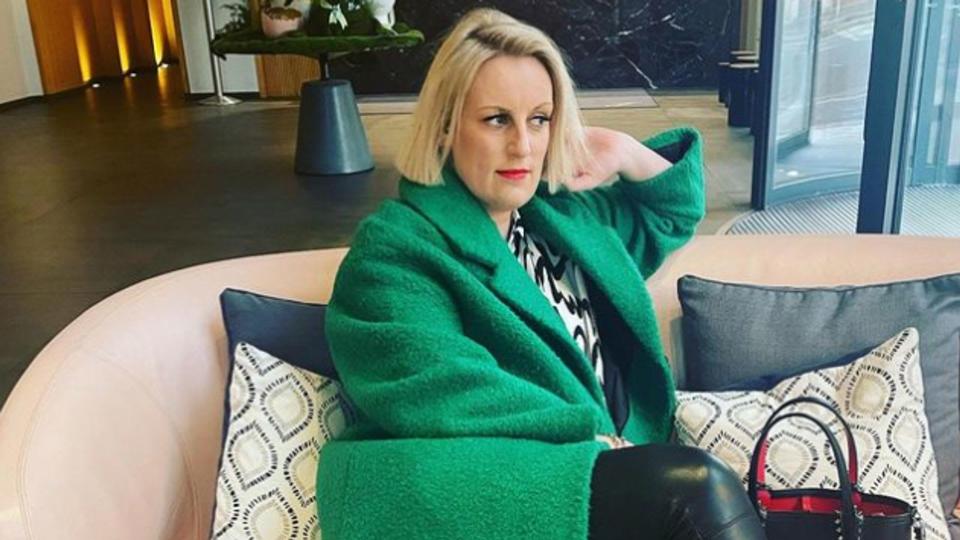 Steph McGovern looking morose in green overcoat and leather trousers