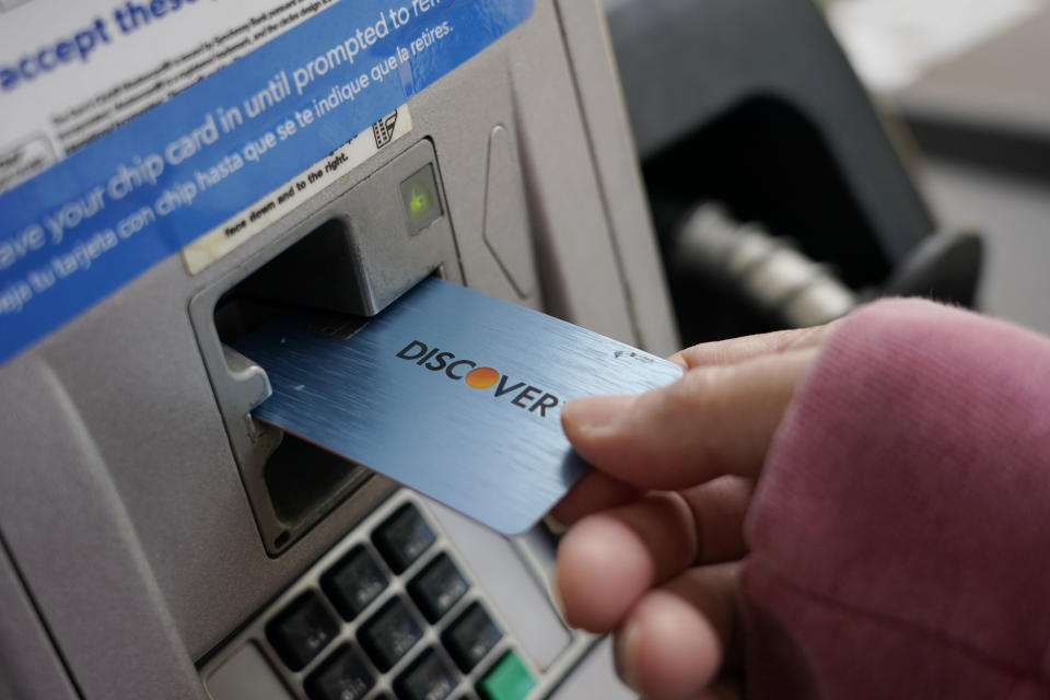 File - A Discover card is used to pay for gasoline at a Sam's Club in Madison, Miss., July 1, 2021. Capital One Financial is buying Discover Financial Services for $35 billion, in a deal that would bring together two of the nation's biggest lenders and credit card issuers. (AP Photo/Rogelio V. Solis, File)