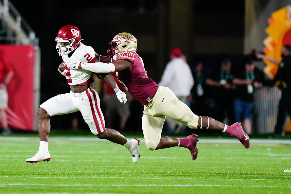 Dec 29, 2022; Orlando, Florida, USA; Florida State Seminoles defensive lineman Jared Verse (5) tackles Oklahoma Sooners running back Jovantae Barnes (2) during the second half in the 2022 Cheez-It Bowl at Camping World Stadium. Mandatory Credit: Rich Storry-USA TODAY Sports