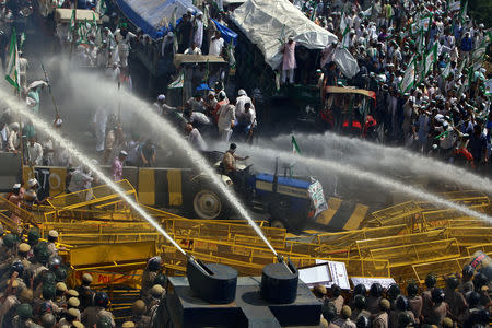 Police use water cannons to disperse farmers during a protest demanding better price for their produce on the outskirts of New Delhi, October 2, 2018. REUTERS/Stringer