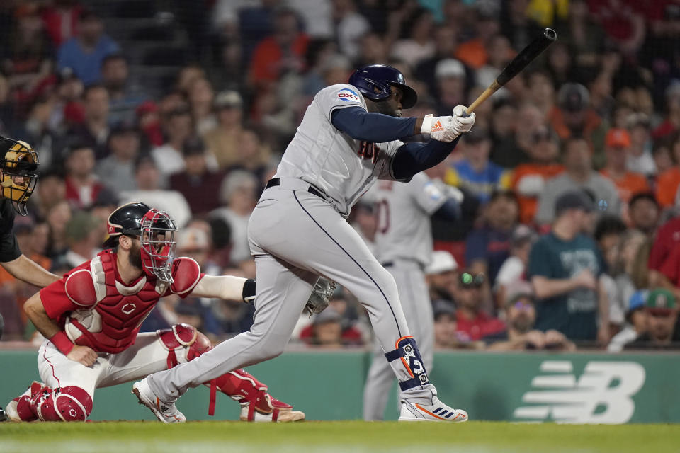 Houston Astros' Yordan Alvarez, right, hits a three-run home run as Boston Red Sox catcher Connor Wong, left, looks on in the sixth inning of a baseball game, Monday, Aug. 28, 2023, in Boston. (AP Photo/Steven Senne)