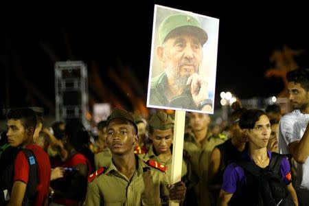 REFILE - CORRECTING BYLINE - A cadet carries an image of former Cuban leader Fidel Castro at a tribute to Castro in Santiago de Cuba, Cuba, December 3, 2016. REUTERS/Ivan Alvarado