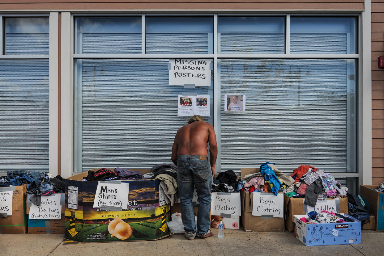 A man looks through clothing at a donation site in Lahaina, Maui, Hawaii on Aug. 16, 2023. (Josiah Patterson for NBC News)