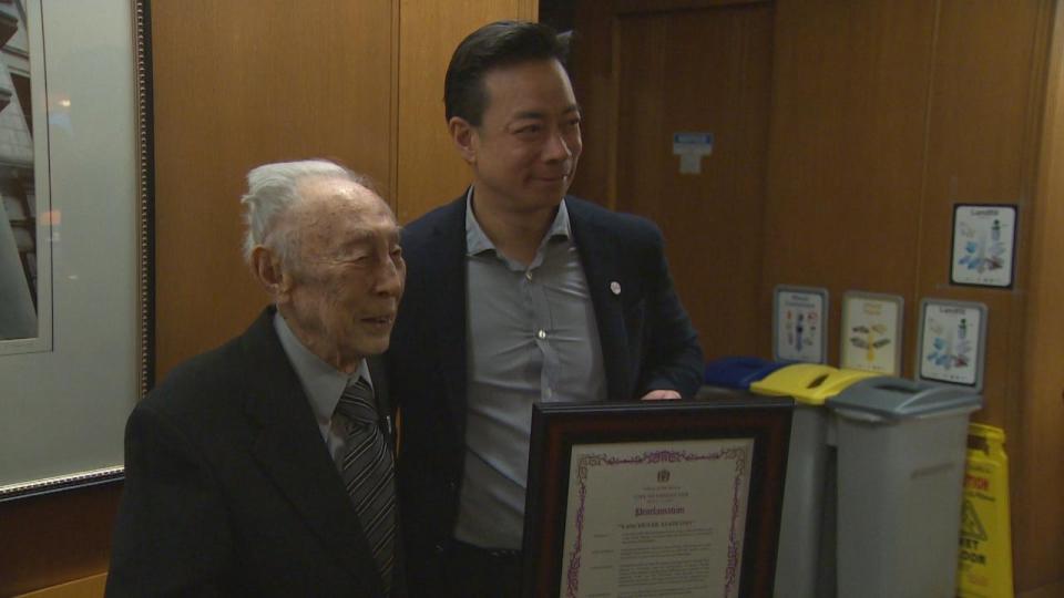 Vancouver mayor Ken Sim, right, declared Thursday 'Vancouver Asahi Day' to honour the iconic baseball team and celebrate the 102nd birthday of the last suriving player, Kaye Kaminishi (left). 