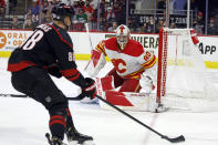 Calgary Flames' Dan Vladar watches the puck controlled by Carolina Hurricanes' Martin Necas during the second period of an NHL hockey game in Raleigh, N.C., Sunday, March 10, 2024. (AP Photo/Karl B DeBlaker)