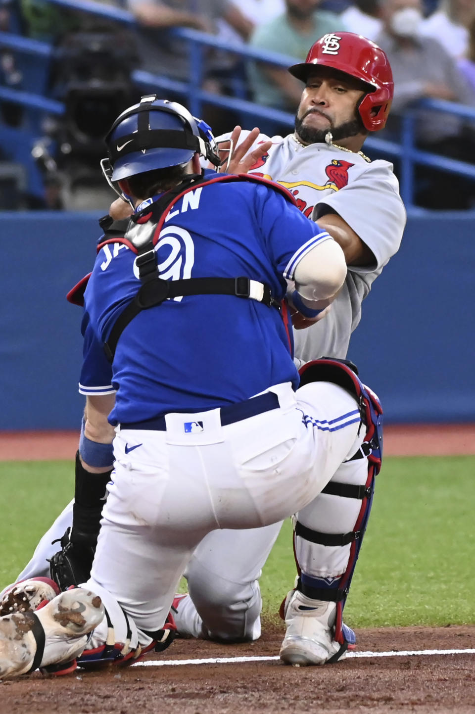 St. Louis Cardinals' Albert Pujols, right, is tagged out at home by Toronto Blue Jays catcher Danny Jansen during the fourth inning of a baseball game Wednesday, July 27, 2022, in Toronto. (Jon Blacker/The Canadian Press via AP)