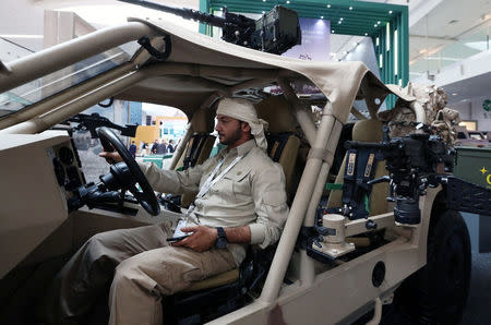 A man sits in a vehicle on display during the International Defence Exhibition and Conference (IDEX) in Abu Dhabi, United Arab Emirates February 19, 2017. REUTERS/Stringer