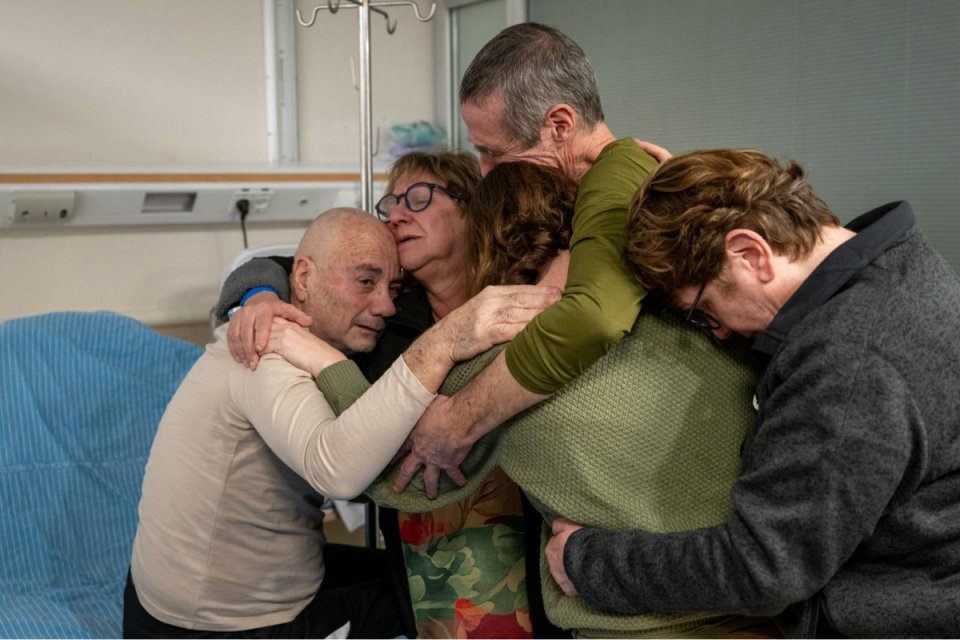 Israeli hostages Fernando Simon Marman and Louis Hare reuniting with loved ones at Sheba Medical Center (via REUTERS)