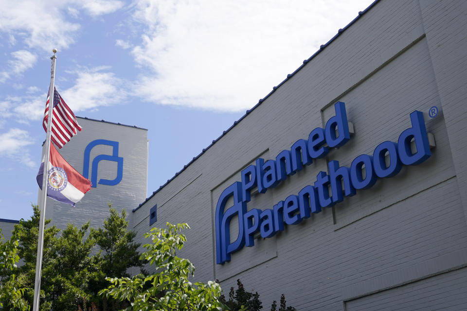 FILE - Missouri and American flags fly outside Planned Parenthood June 24, 2022, in St. Louis. Planned Parenthood, the nation's leading reproductive health care provider and abortion rights advocacy organization, plans to spend a record $50 million ahead of November's midterm elections, pouring money into contests where access to abortion will be on the ballot. (AP Photo/Jeff Roberson, File)