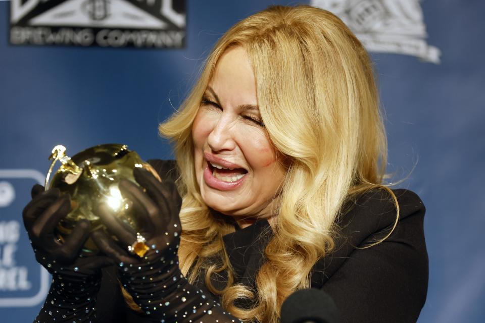 Jennifer Coolidge holds the Pudding Pot during a news conference following a roast honoring her as Harvard's Hasty Pudding Theatricals Woman of the Year, Saturday, Feb. 4, 2023, in Cambridge, Mass. (AP Photo/Michael Dwyer)