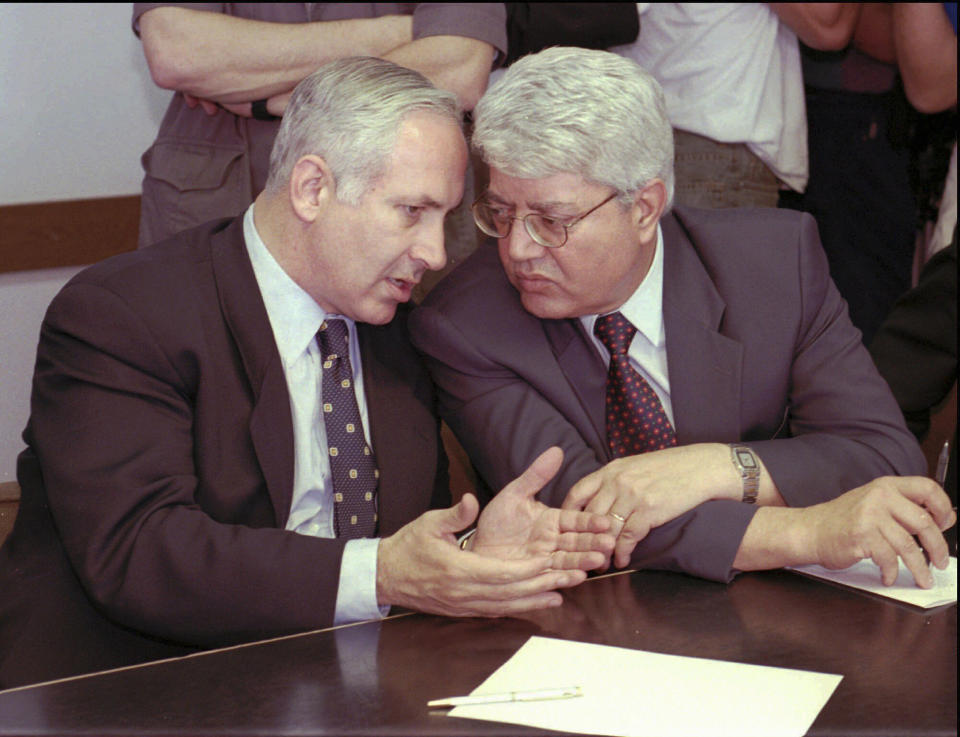 FILE - Future Israeli Foreign Minister David Levy, right, pays close attention to Prime Minister-elect Benjamin Netanyahu at a Likud party gathering held at the Knesset, June 17, 1996, in Jerusalem. Levy, an Israeli politician born in Morocco who fought tirelessly against deep-seated racism against Jews from North Africa and went on to serve as foreign minister and hold other senior governmental posts, died Sunday, June 2, 2024. He was 86. (AP Photo/Greg Marinovich, File)