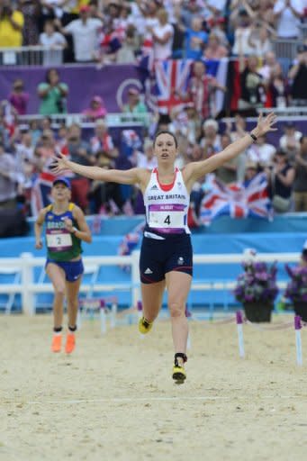 Great Britain's Samantha Murray celebrates winning silver ahead of Brazil's Yane Marques (in the background) at the end of the women's Modern Pentathlon during the 2012 London Olympics at the Equestrian venue in Greenwich Park, London